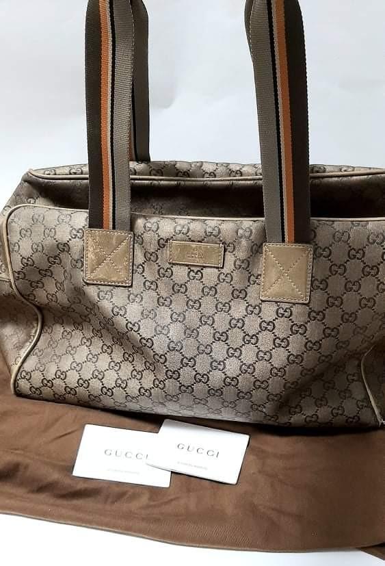 Gucci Travel Bag "Authentic" (Category: Luxury Bags & Wallets) located in Pasay City. Submitted by redgiftshop (Listing ID 1147962010, Image 1). Description: Gucci Travel Bag for Sale for 5,500pesos - authentic and classic- (preloved) still in a good condition with inside pocket, see pictures for detailed image, some damage at the bottom sides and supposed to be shiny but still usable. comes with dust bag, for interested buyer we can deliver or s