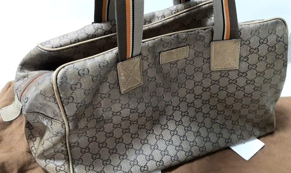 Gucci Travel Bag "Authentic" (Category: Luxury Bags & Wallets) located in Pasay City. Submitted by redgiftshop (Listing ID 1147962010, Image 3). Description: Gucci Travel Bag for Sale for 5,500pesos - authentic and classic- (preloved) still in a good condition with inside pocket, see pictures for detailed image, some damage at the bottom sides and supposed to be shiny but still usable. comes with dust bag, for interested buyer we can deliver or s