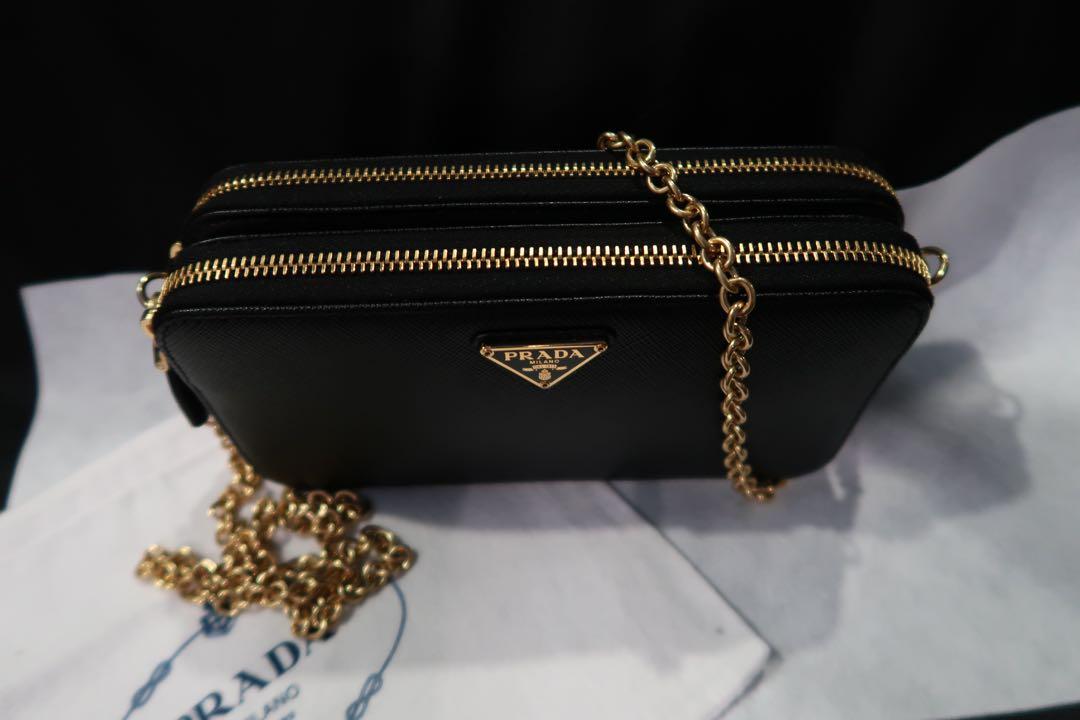 Prada double zip bag with chain (Category: Luxury Bags & Wallets) located in Bocaue. Submitted by declutteting2017 (Listing ID 1142216773, Image 2). Description: used 3x 100% authentic Saffiano leather Box, paperbag, cards, dustbag Store fresh! Bought jan 9, 2022 stamped Sa prada store. Bought this for 52,000. .