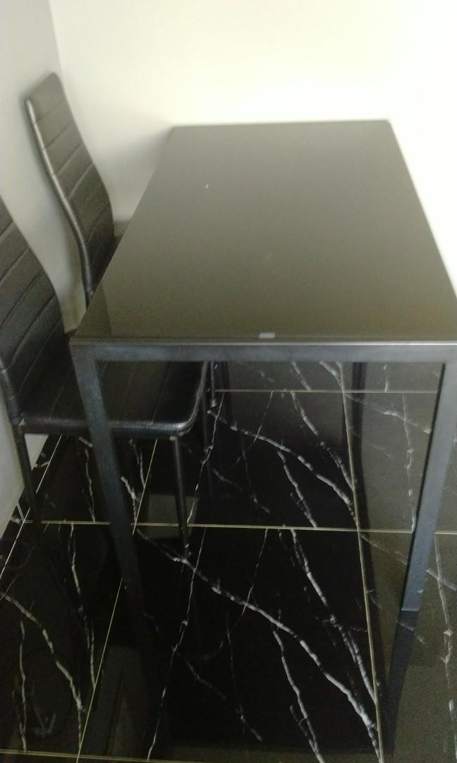 Dining table (Category: Tables & Sets) located in Singapore. Submitted by lanaimperio (Listing ID 1157184856, Image 1). Description: Black Dining Table only still in good condition. Tampered glass Table condition 8/10 If want chair, can take also but the condition of the chair is 5-6/10 self collect at punggol arrange own transport.