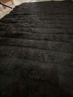 black velvety carpet rug