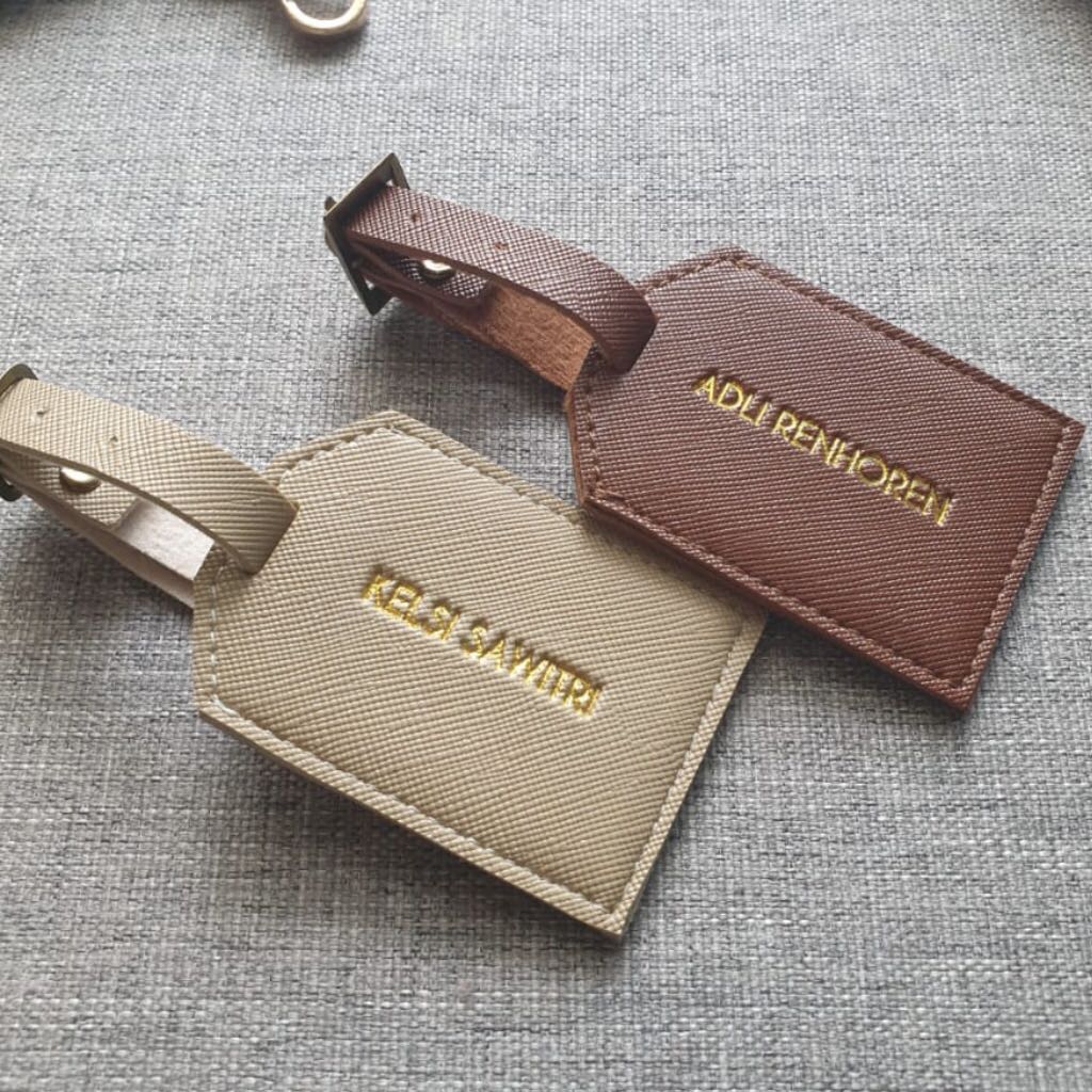 Embossed luggage tag store