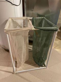 Laundry hamper with two sections Plastic frame and white and green mesh drawstring bags without rips Knocks down for easy storage and transport  22” wide x 18” deep x 28” high