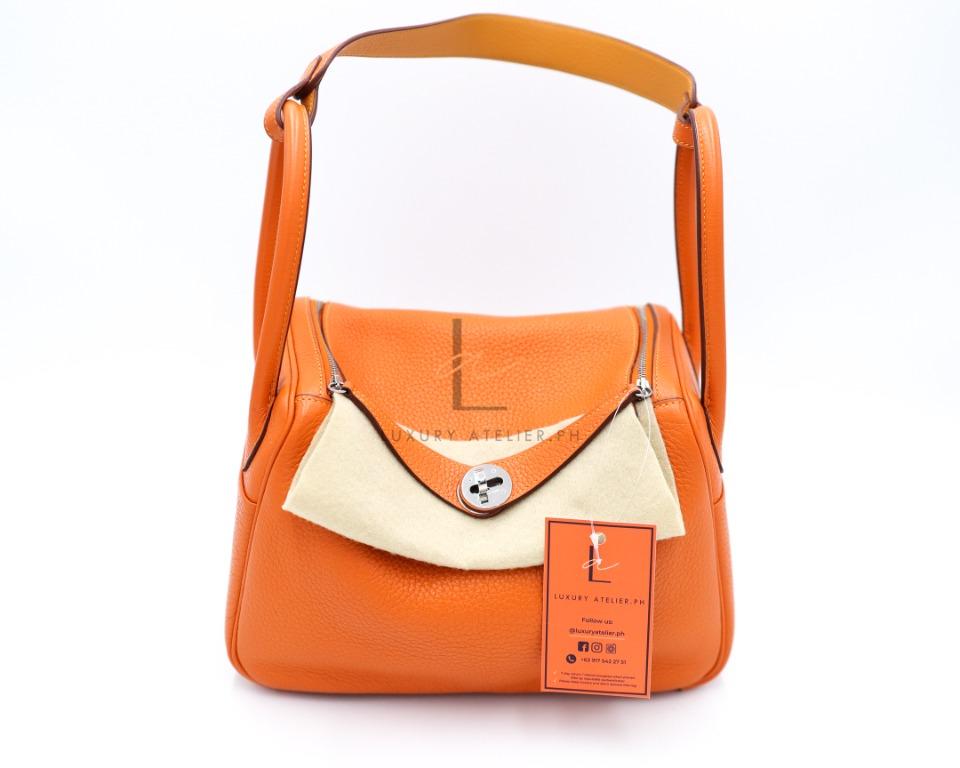 Hermes Lindy 26 Like New On hand (Category: Luxury Bags & Wallets) located in Paranaque City. Submitted by luxuryatelier.ph (Listing ID 1147789675, Image 2). Description: CASH: Php 406,100 only CARD* / LAYAWAY* / PAYPAL: Php 423,000 only (*3 months installment) Model: Lindy 26; Date Code: Q - 2013 Condition: 8.5-9/10 Excellent (Very minimal signs of usage) Material: Clemence; Color: Classic Orange; Hardware: PHW Size: 26*13*18, handle: 13cm; stra