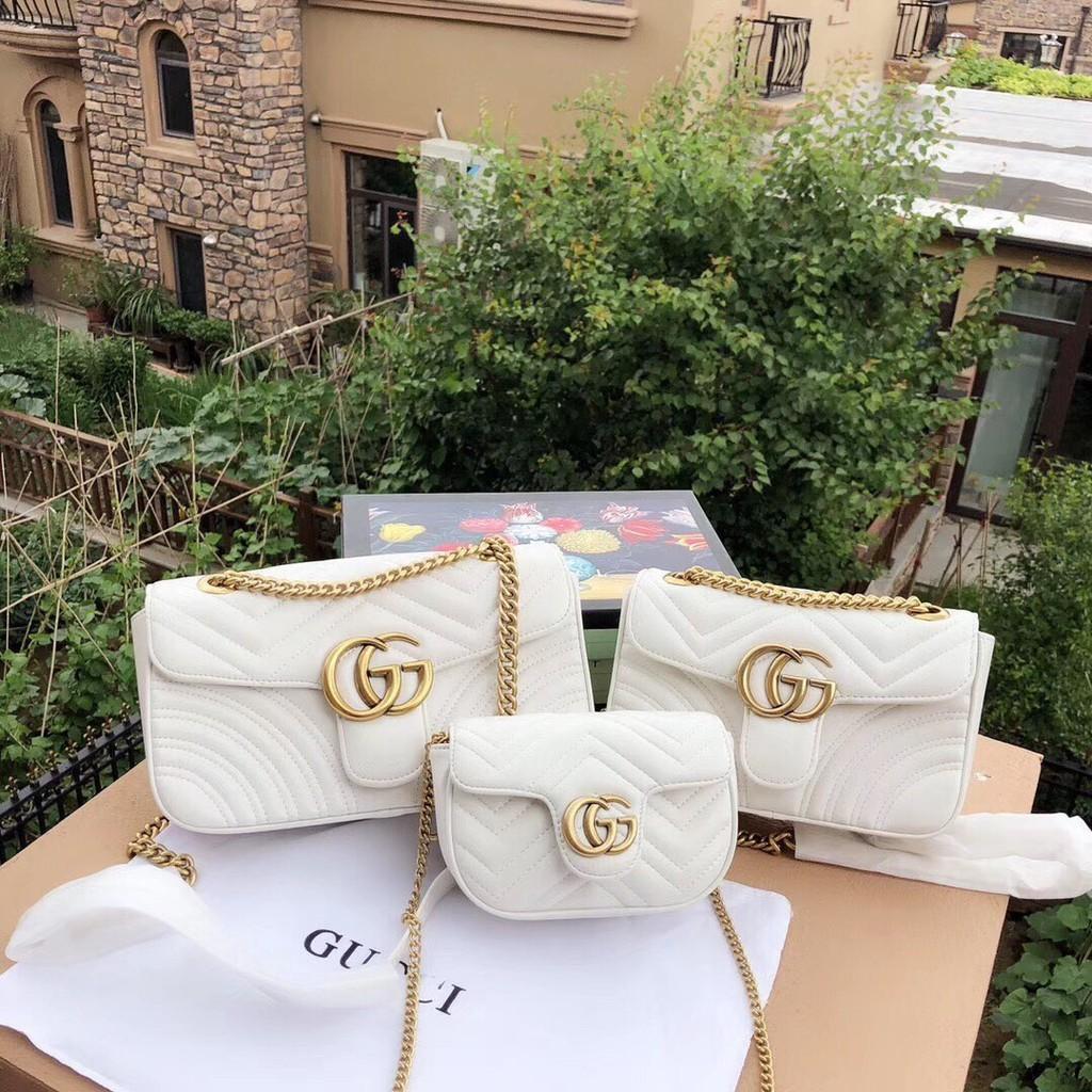 White bag top with gold chain