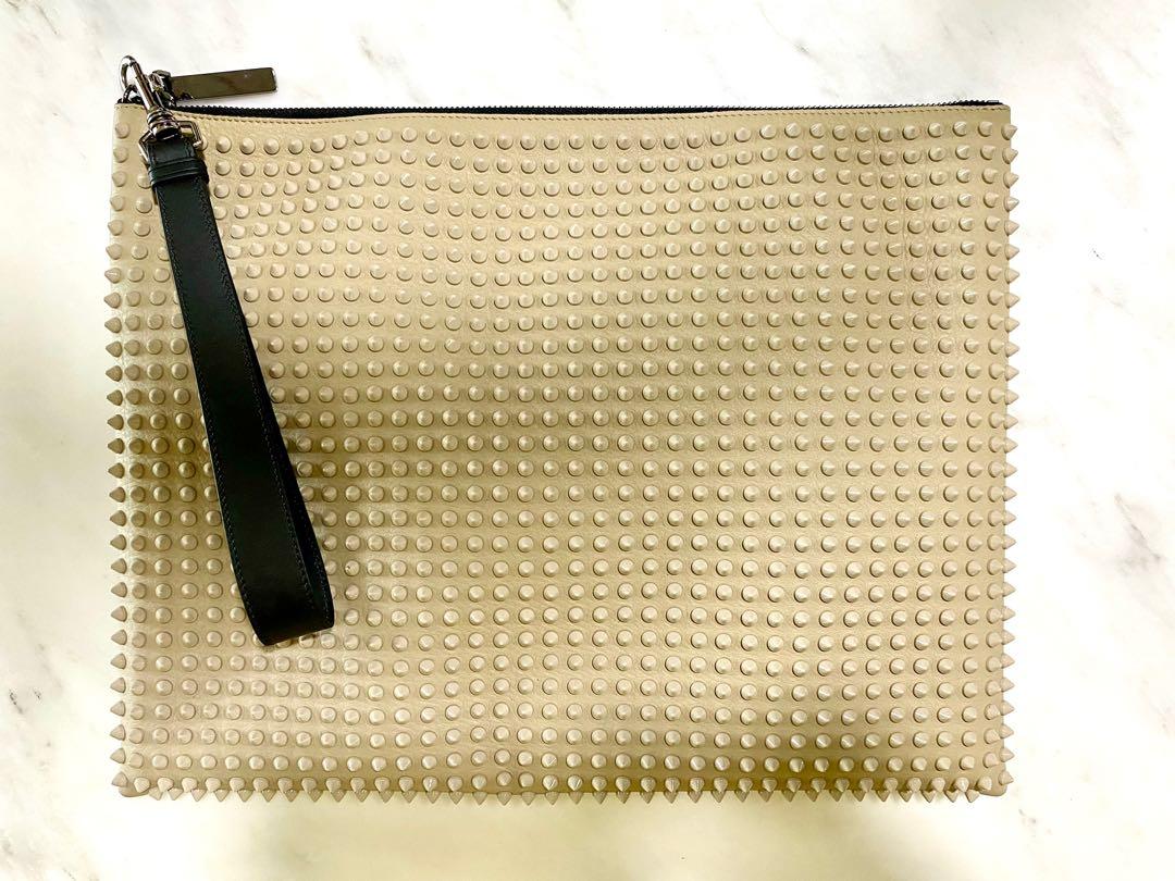 Christian Louboutin Peter Spiked Leather Pouch (Category: Luxury Bags & Wallets) located in Pasig City. Submitted by capsulecollection (Listing ID 1159942253, Image 1). Description: Christian Louboutin studded leather pouch in beige. Size: 15” x 12”.