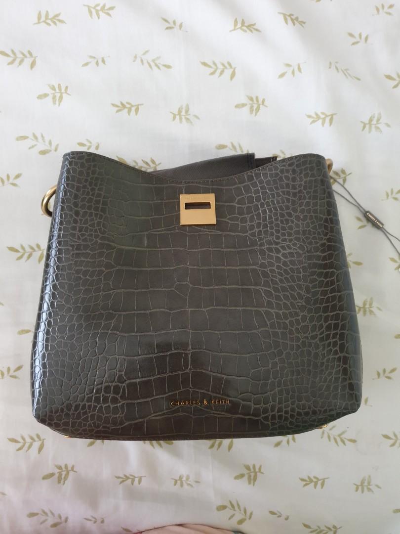 Charles and Keith green croc bag (Category: Shoulder Bags) located in Quezon City. Submitted by declutteringwithcris (Listing ID 1160363923, Image 1). Description: Brand new Charles and Keith Green Faux Croc Bag Inclusions: Dust Bag Short and Long strap Box- paper peeled off on the outside of the box due storage.