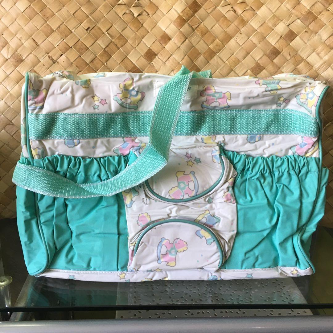 Green Baby Bag (Category: Other Babies Going Out Needs) located in Manila. Submitted by thebookclubz (Listing ID 1160399662, Image 1). Description: Baby diaper bag Has pockets for bottles Comes with a changing mat for changing outside .