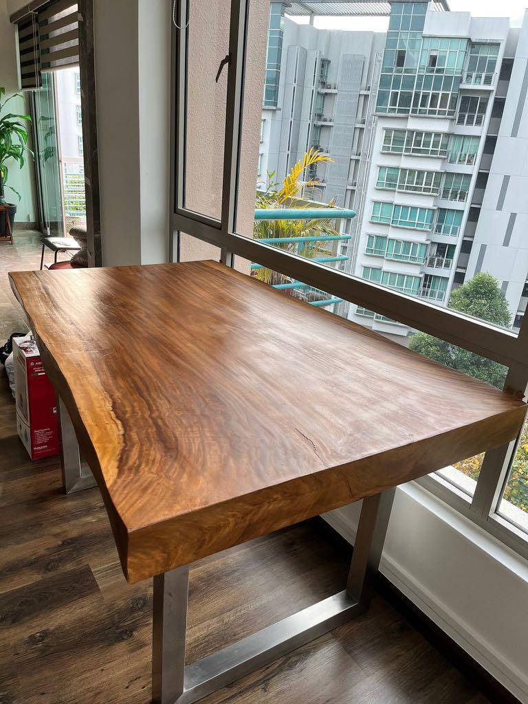 Solid Wood Table (Category: Tables & Sets) located in Singapore. Submitted by chloe589 (Listing ID 1160370678, Image 2). Description: Beautiful solid natural timber table with steel legs 83cm tall, 152 cm long. Breadth is 96 cm (at its widest) and 85 cm at its narrowest. Width a bit irregular because it’s natural timber (about 10cm) **there is a natural crack at one of the ends, picture in 8th slide Can be used as a dining table for 4 pax or a be