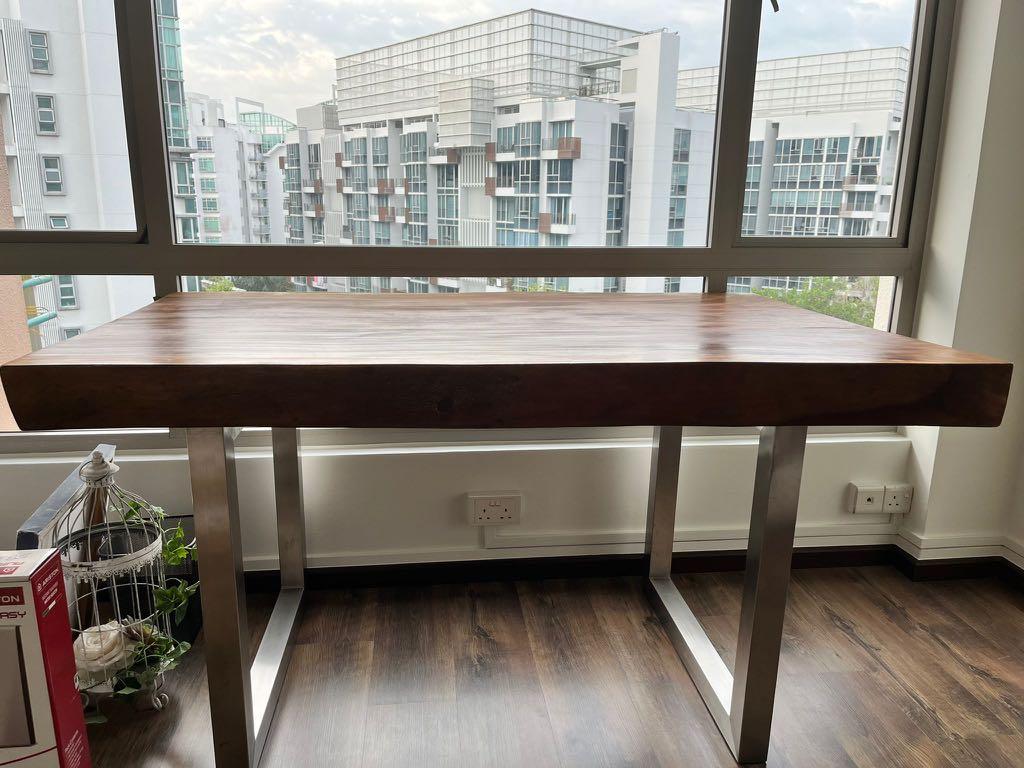 Solid Wood Table (Category: Tables & Sets) located in Singapore. Submitted by chloe589 (Listing ID 1160370678, Image 3). Description: Beautiful solid natural timber table with steel legs 83cm tall, 152 cm long. Breadth is 96 cm (at its widest) and 85 cm at its narrowest. Width a bit irregular because it’s natural timber (about 10cm) **there is a natural crack at one of the ends, picture in 8th slide Can be used as a dining table for 4 pax or a be