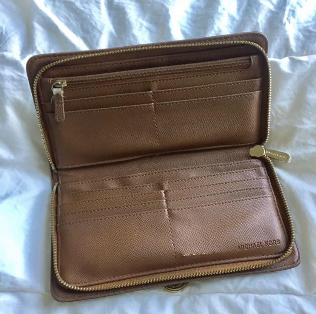 Michael Kors Long Wallet (Category: Luxury Bags & Wallets) located in Taguig. Submitted by sambunny (Listing ID 1160647496, Image 2). Description: 💯Original MK long wallet genuine leather (please stop asking for code, no code and forget about the box because this is my preloved ☺️ plus, halata naman ang fake sa orig with the leather and zipper. & I don't buy fake leather items) 😊Used leather conditioner so the leather canvass is still in very g