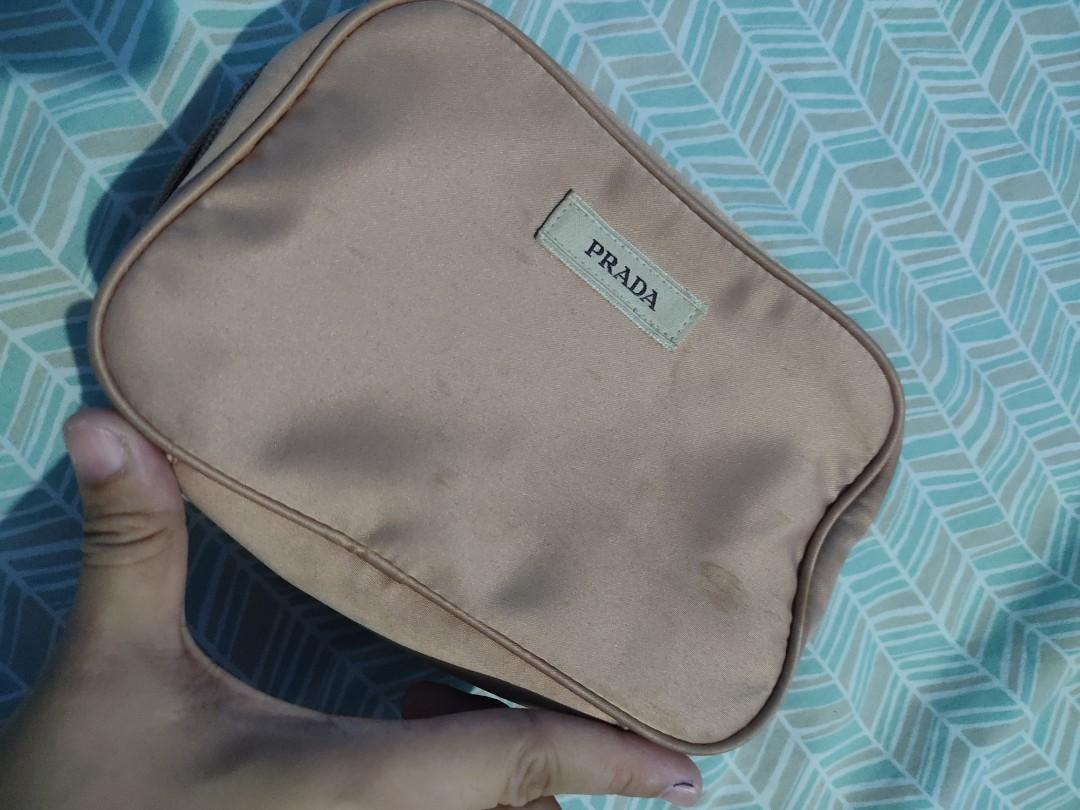 Prada Makeup Pouch (Category: Luxury Bags & Wallets) located in Lian. Submitted by mickeys_preloved (Listing ID 1160627170, Image 3). Description: needs washing nastock lang sa cabinet light pink/peach in actual 7x5 inches authentic prada free shipping.