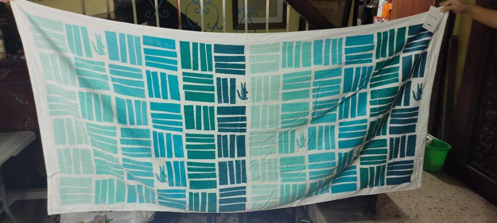 LACOSTE GRADIENT GEOMETRIC COTTON BEACH TOWEL (Category: Bedding & Towels) located in Valenzuela. Submitted by francissilva5667 (Listing ID 1162194501, Image 1). Description: BRAND NEW ON HAND ITEM SAME DAY DELIVERY Stay comfortable and stylish while you soak up some sun with the help of this super-soft cotton beach towel from Lacoste, featuring a gradient geometric pattern with croc logo accents and an absorbent terry cloth reverse. Dimensions: 