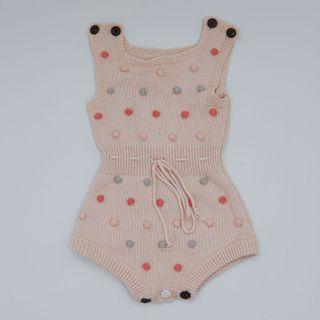 pink knitted romper with pompoms