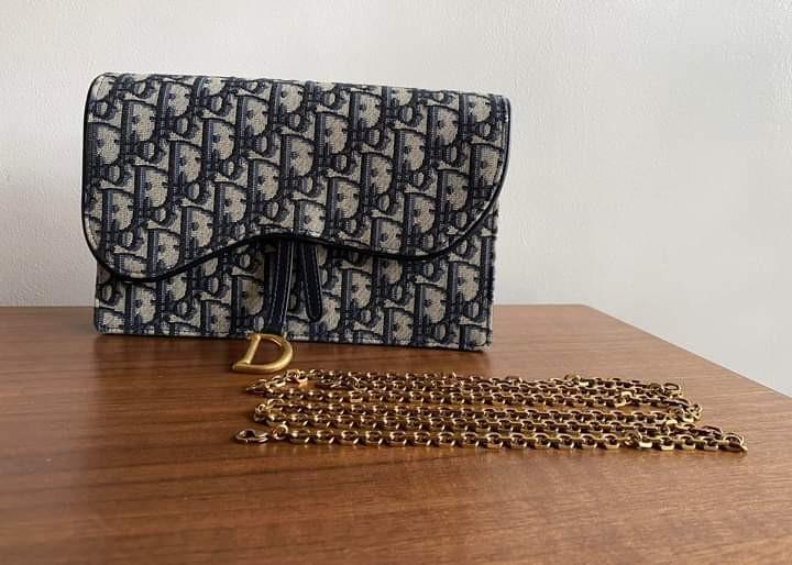 Dior Saddle Pouch Clutch On Chain (Category: Luxury Bags & Wallets) located in Manila. Submitted by bagislifeshop (Listing ID 1162592212, Image 2). Description: BRANDNEW DIOR SADDLE POUCH CLUTCH ON CHAIN Multi-Way Clutch w/ Removable Chain Classic Blue Oblique Jacquard Canvas Brassed Gold Tone Hardware Dimensions-8.5”x5.5”x1.5” Chain length: 120 cm / 47 inches 4 card slots 1 patch pocket 1 zipped pocket Middle Compartment Can Fit All iPhone Model