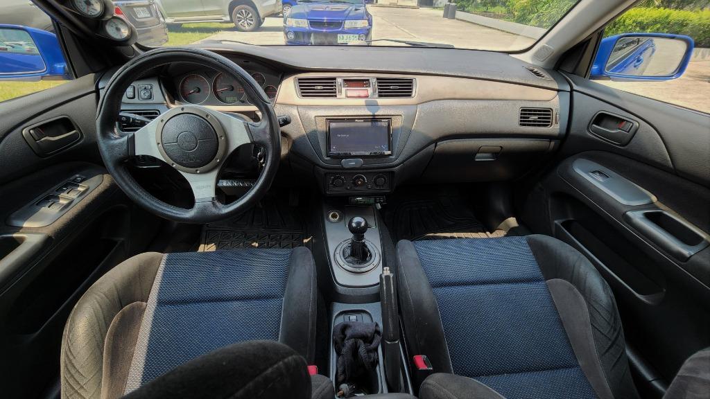 Mitsubishi Lancer Evolution VII GSR (M) (Category: Used Cars) located in Pasig City. Submitted by elmcarstrading (Listing ID 1165782816, Image 2). Description: 2002 Mitsubishi Lancer Evolution 7 (JDM) ✅ CT9A chassis number and Lancer Evolution indicated in Registration ✅ Origjnal Paint ✅ 5 Speed Manual Transmission ✅ Quick Steer ✅ HKS BOV ✅ HKS Boost Controller ✅ HKS mushroom cold air Intake ✅ Apexi Turbo Timer ✅ Defi Gauges ✅ Volk Rays CE28 (Ori