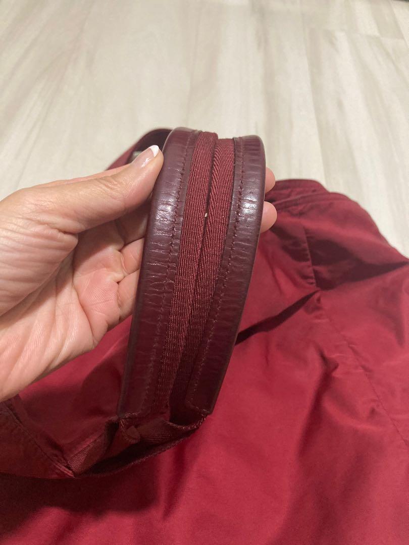 Prada (Category: Shoulder Bags) located in Singapore. Submitted by declutter122 (Listing ID 1165947048, Image 4). Description: Selling authentic Prada Nylon Bags which I have kept for years! 1) Red colour (BR4055 Vela Cerise) - inner lining of the bag is torn and it’s about 9.5inches - maximum width of bag is about 24.5 inches and length 15 inches - really pretty and chic color and you can send to bag spa to stitch inner lining/ clean the bag - s