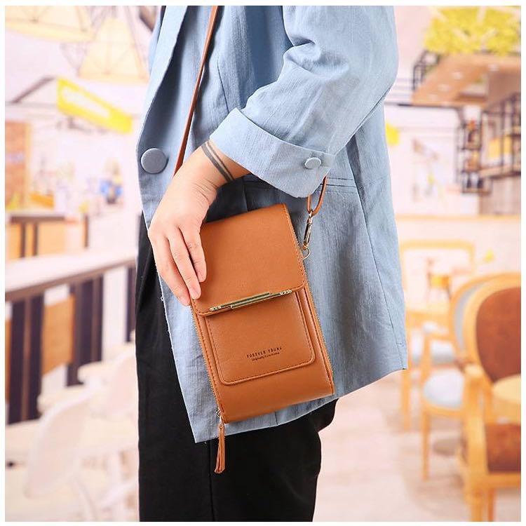Sling bag with phone pocket outlet