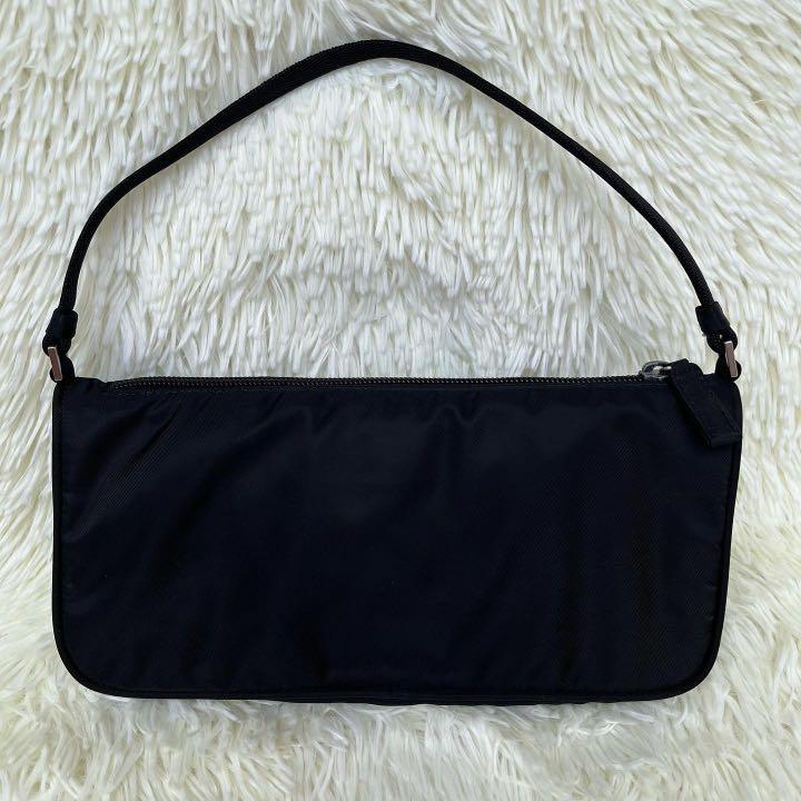 Black Prada Nylon Baguette Bag (Category: Luxury Bags & Wallets) located in Las Pinas. Submitted by Le.Pattie.Luxe (Listing ID 1166567158, Image 2). Description: Authentic Prada Nylon Baguette /Kilikili Bag 🖤Php 22k🖤 ▪️Excellent condition, no discoloration nor faded area. Normal signs of use only like slight tarnishing on the zipper hardware. ▪️Can be worn as hand/shoulder bag ▪️Inclusion: provided satin dustbag ✨Follow/like our shop page to ge