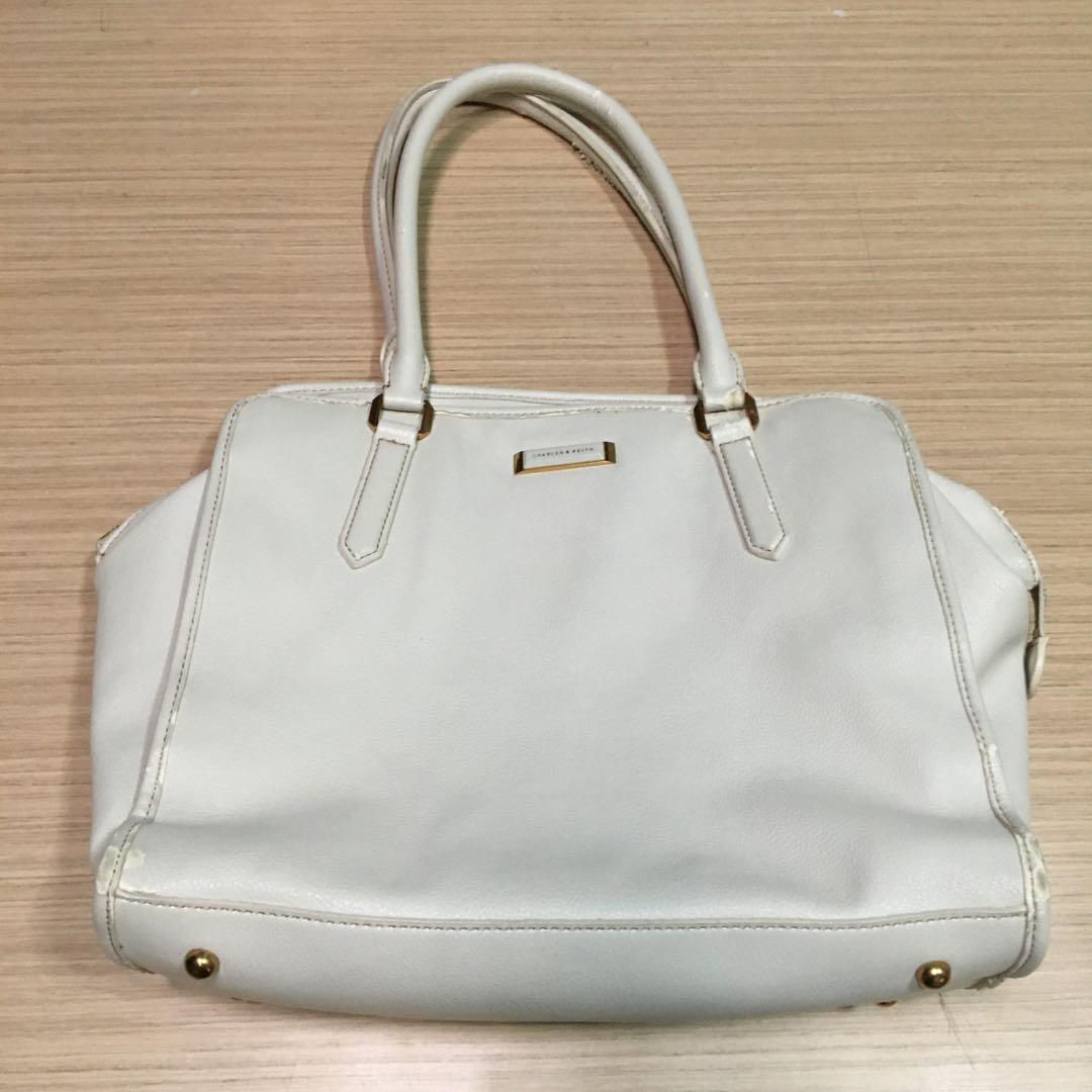 Charles & Keith cream shoulderbag / bodybag (Category: Shoulder Bags) located in Makati City. Submitted by theduchesss (Listing ID 1166818288, Image 2). Description: Authentic Charles & Keith - cream / off-white in color - has extra strap for cross body wear - cleaned / sanitized and ready for use HONEST FLAW: some parts has its leather chipping off, but it's barely noticeable; recently applied leather conditioner .