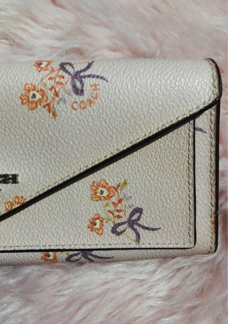 Coach Floral Long Wallet (Category: Luxury Bags & Wallets) located in Norzagaray. Submitted by ravenglamshop (Listing ID 1167390284, Image 2). Description: Original Coach long wallet Super pretty in actual Like new Small flaw (pic 4 yellowing around the snap button) .