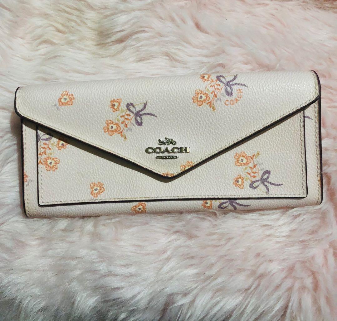 Coach Floral Long Wallet (Category: Luxury Bags & Wallets) located in Norzagaray. Submitted by ravenglamshop (Listing ID 1167390284, Image 1). Description: Original Coach long wallet Super pretty in actual Like new Small flaw (pic 4 yellowing around the snap button) .