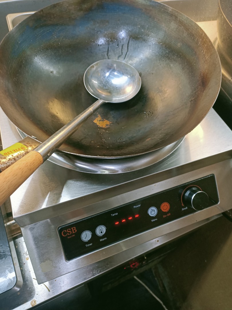 round bottom wok on electric stove