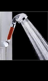 Shower head with filter beads