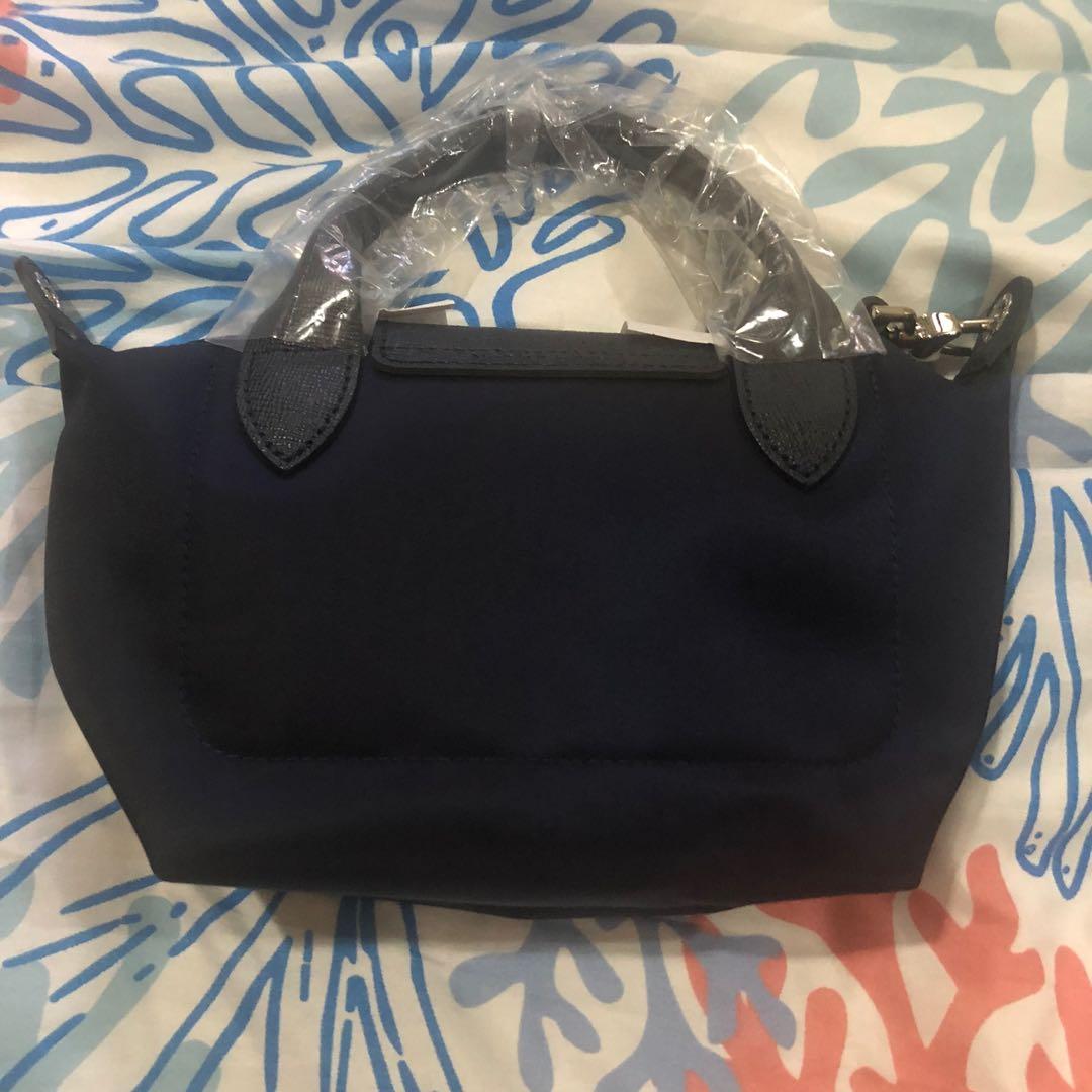 BRAND NEW AUTHENTIC LONGCHAMP NEO XS (Category: Purses & Pouches) located in Mandaluyong City. Submitted by katinka16 (Listing ID 1155080010, Image 3). Description: Brand new, discontinued longchamp NEO Xs. Perfect crossbody strap for travel. This is made out of nylon and leather. Only in navy colour. .