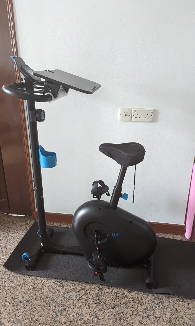 Stationary bike with laptop holder store