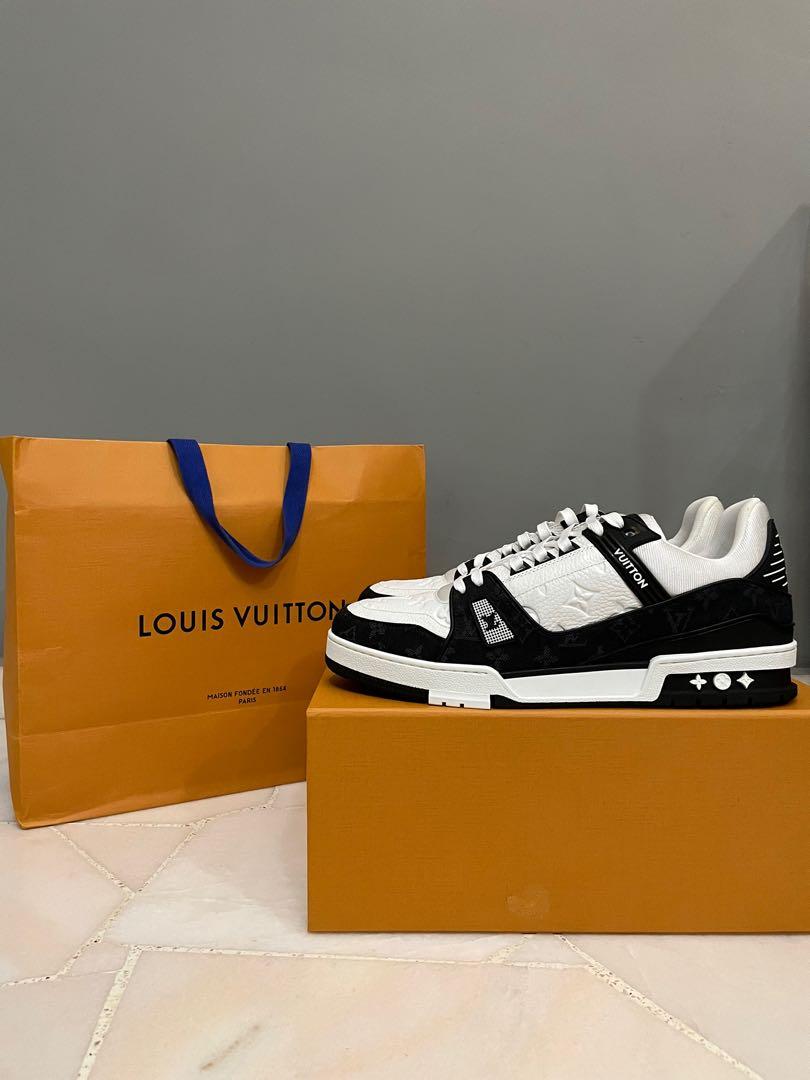 Man with Orange and Black Louis Vuitton Sneakers before Marco