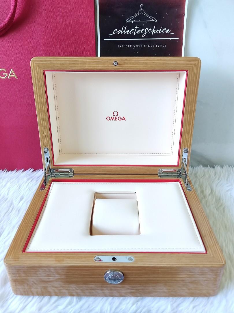Omega Wooden Watch Box (Complete Set) (Category: Luxury Watches) located in Makati City. Submitted by _collectorschoice_ (Listing ID 1172201809, Image 3). Description: ° Brand: Omega ° White outer box signed with Omega logo °Wooden watch box with white/red interior & watch pillow ° With hidden storage ° Condition: Never used ° Inclusions: Large paperbag, manual, white outer box, large wooden box ° Shape: Rectangle ° 100% authentic ° Heavy ° MOP: 