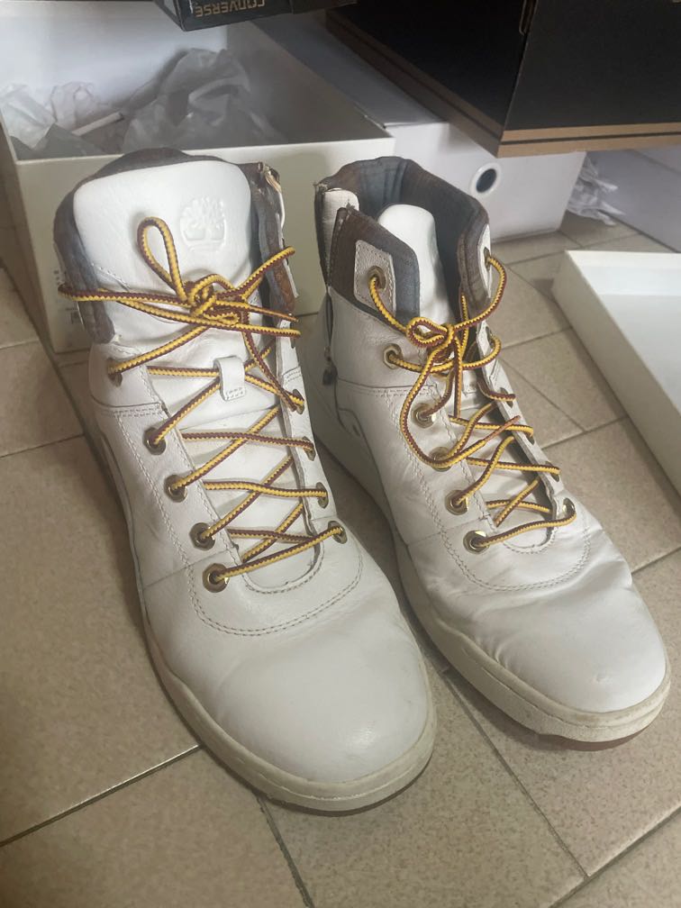 all white timberland boots with gold chain