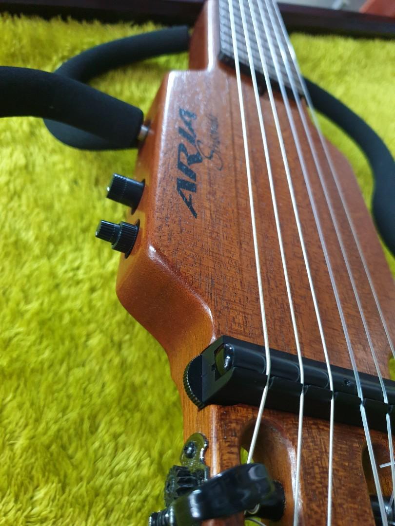 Aria Sinsonido Silent Guitar (Category: Musical Instruments) located in Manila. Submitted by racz03 (Listing ID 1172713260, Image 3). Description: New Arrival From Japan. Aria Sinsonido Silent Acoustic Travel Guitar. License by SoloEtte U.S.A Serial no. 2401468 Excellent Working Condition. Low Action with Truss rod. New Nylon String Installed. With Free 9V Batterry & Cable Cord..