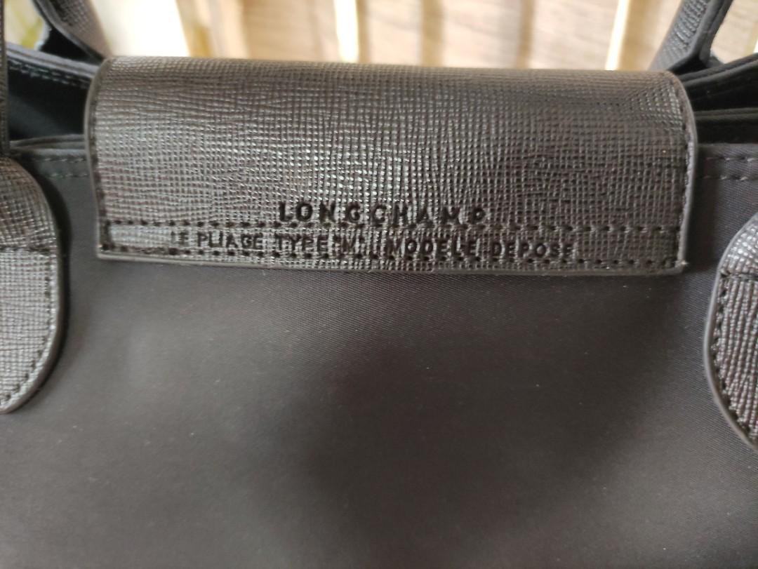 Black Longchamp Top-handle bag (Category: Luxury Bags & Wallets) located in San Pedro. Submitted by recitea (Listing ID 1172924093, Image 3). Description: I am selling my pre-loved black longchamp top-handle bag. This is not original. Used but not abused. It has 2 compartments with zipper. You can use it when going to the mall, or to the office..