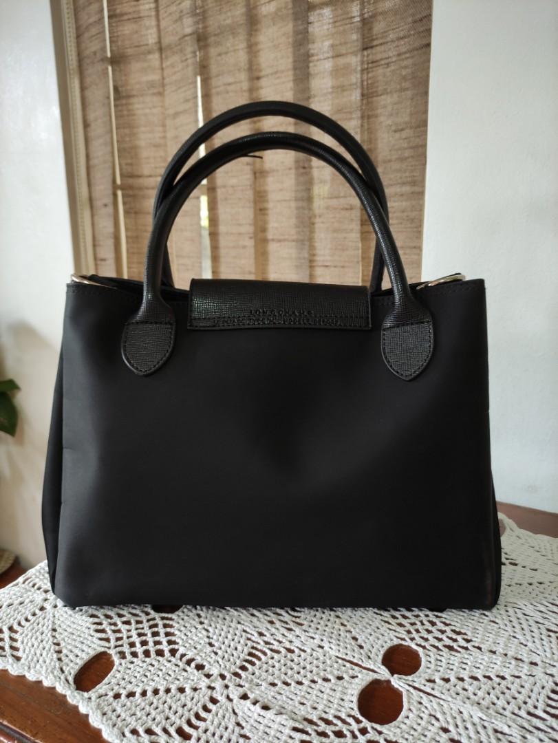 Black Longchamp Top-handle bag (Category: Luxury Bags & Wallets) located in San Pedro. Submitted by recitea (Listing ID 1172924093, Image 2). Description: I am selling my pre-loved black longchamp top-handle bag. This is not original. Used but not abused. It has 2 compartments with zipper. You can use it when going to the mall, or to the office..