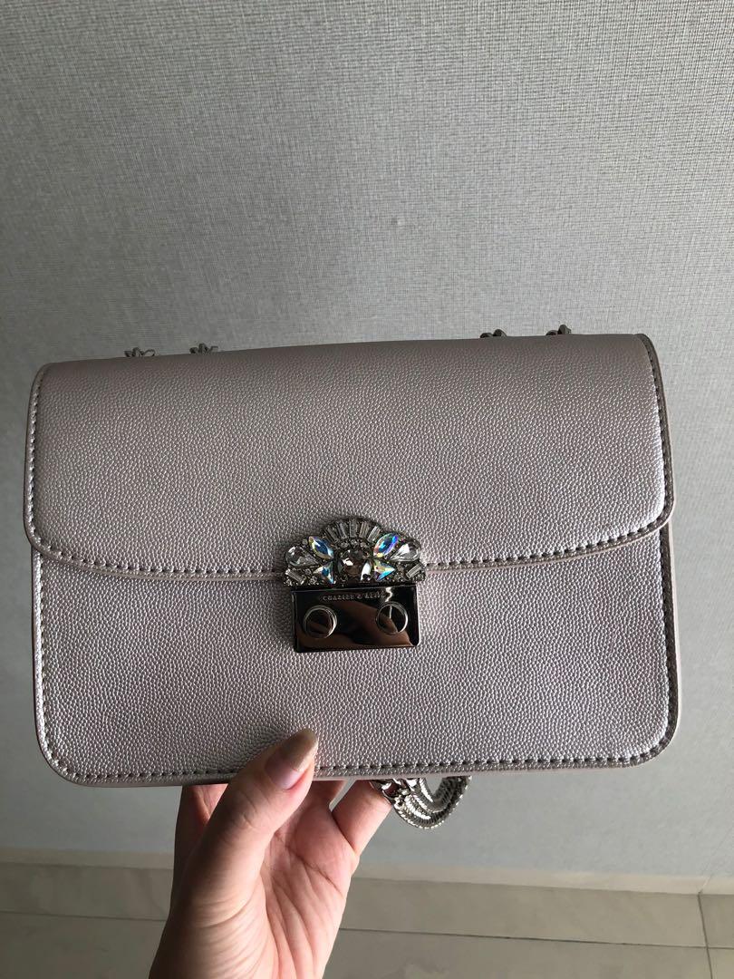 Embellished push lock store clutch