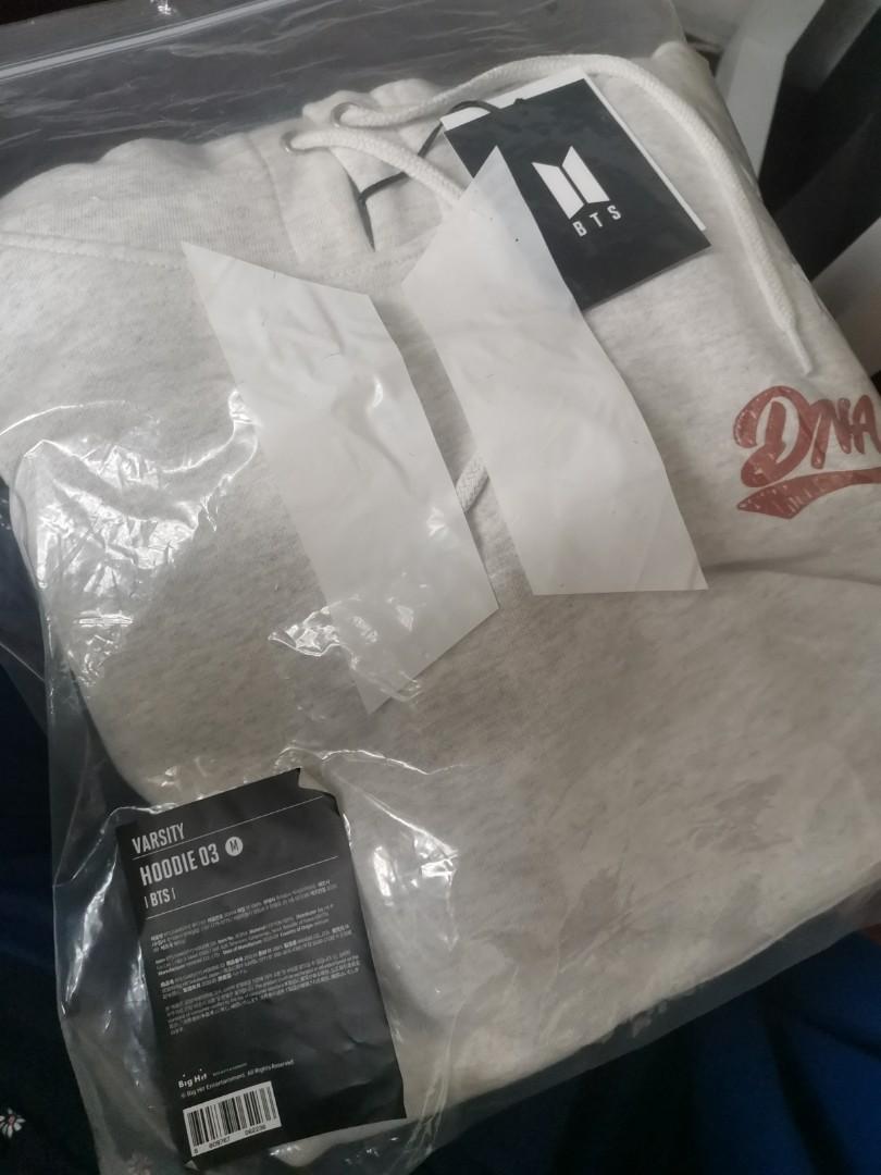BTS Varsity DNA Gray Hoodie (Category: Coats, Jackets and Outerwear) located in Marikina City. Submitted by declutterkpcloset (Listing ID 1174737471, Image 3). Description: Bought at BTS Pop up store Official Never used (complete with ziplock and tags) RFS: Decluttering.