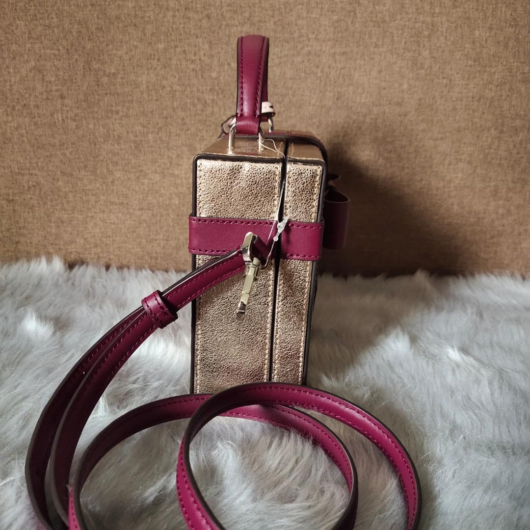 Kate Spade ribbon top handle bag (Category: Luxury Bags & Wallets) located in Santa Cruz. Submitted by phkashoppe (Listing ID 1178336150, Image 3). Description: authentic Kate Spade vanity bag with bow design brand new with tag and care card with detachable/adjustable sling shiny rose gold leather with maroon leather ribbon design gold hardware.