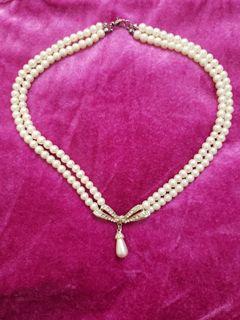 2 Necklaces with faux pearls and the other with black and gold beads.
