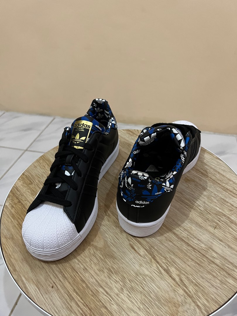 Adidas superstar black motif text