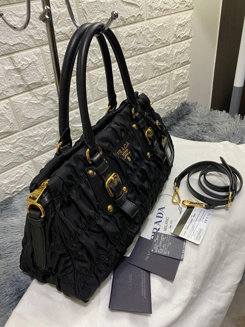 Prada Tessuto Gaufre Nero in GHW (Category: Luxury Bags & Wallets) located in Quezon City. Submitted by christineboller (Listing ID 1179593195, Image 2). Description: Prada Tessuto Gaufre in Nero GHW. In 9.8/10 condition, smells and looks brandnew. BN1407 bought from Prada Daimaru Tokyo, Year 2019. No issue. Outstanding structure, no rubs/scuffs on handles and edges. Comes in full set of authenticity card, care booklet, Prada tag, strap and dustb