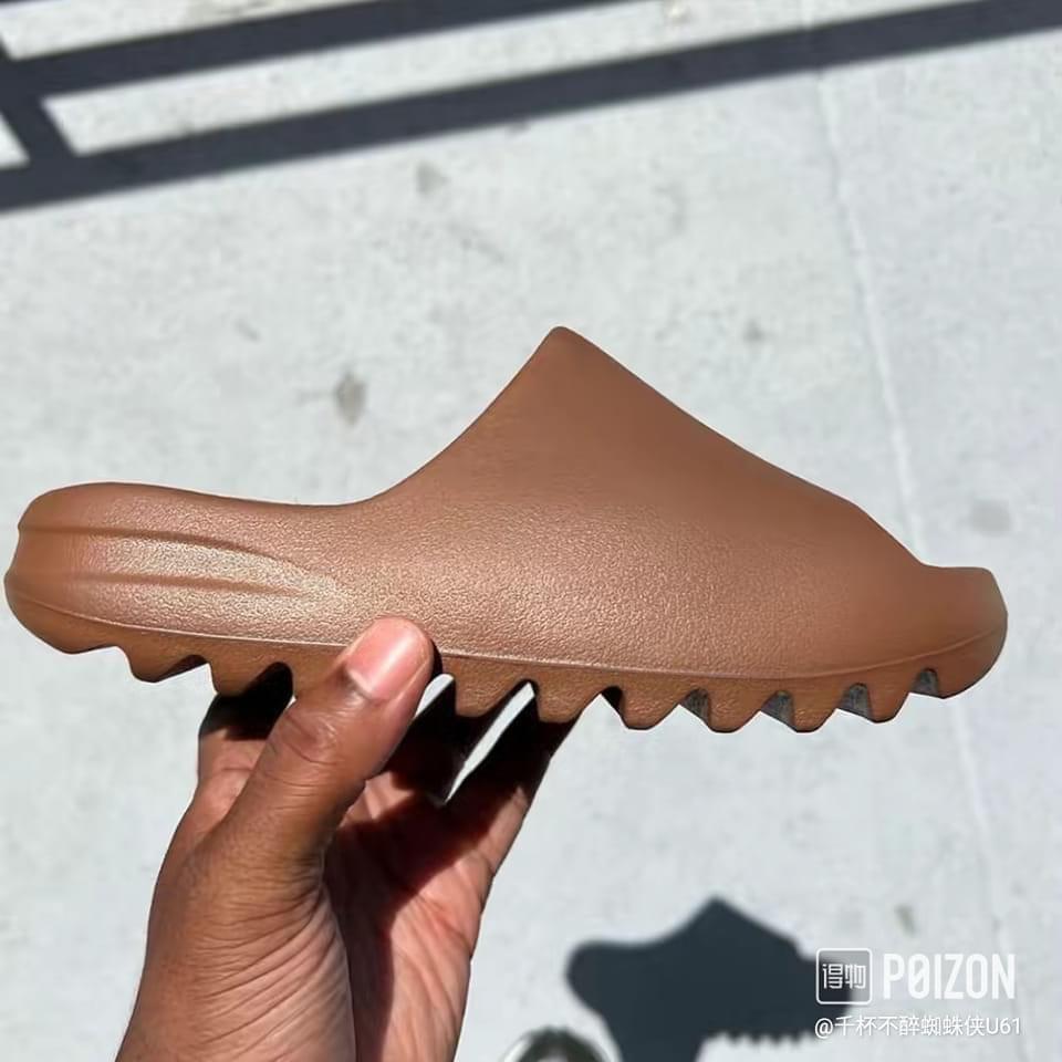 yeezy earth brown slides on feet