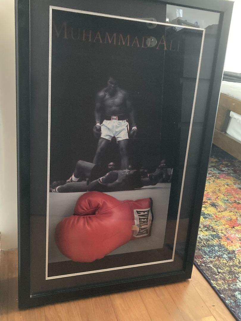 Signed Muhammad Ali boxing glove in cabinet with certificate of
