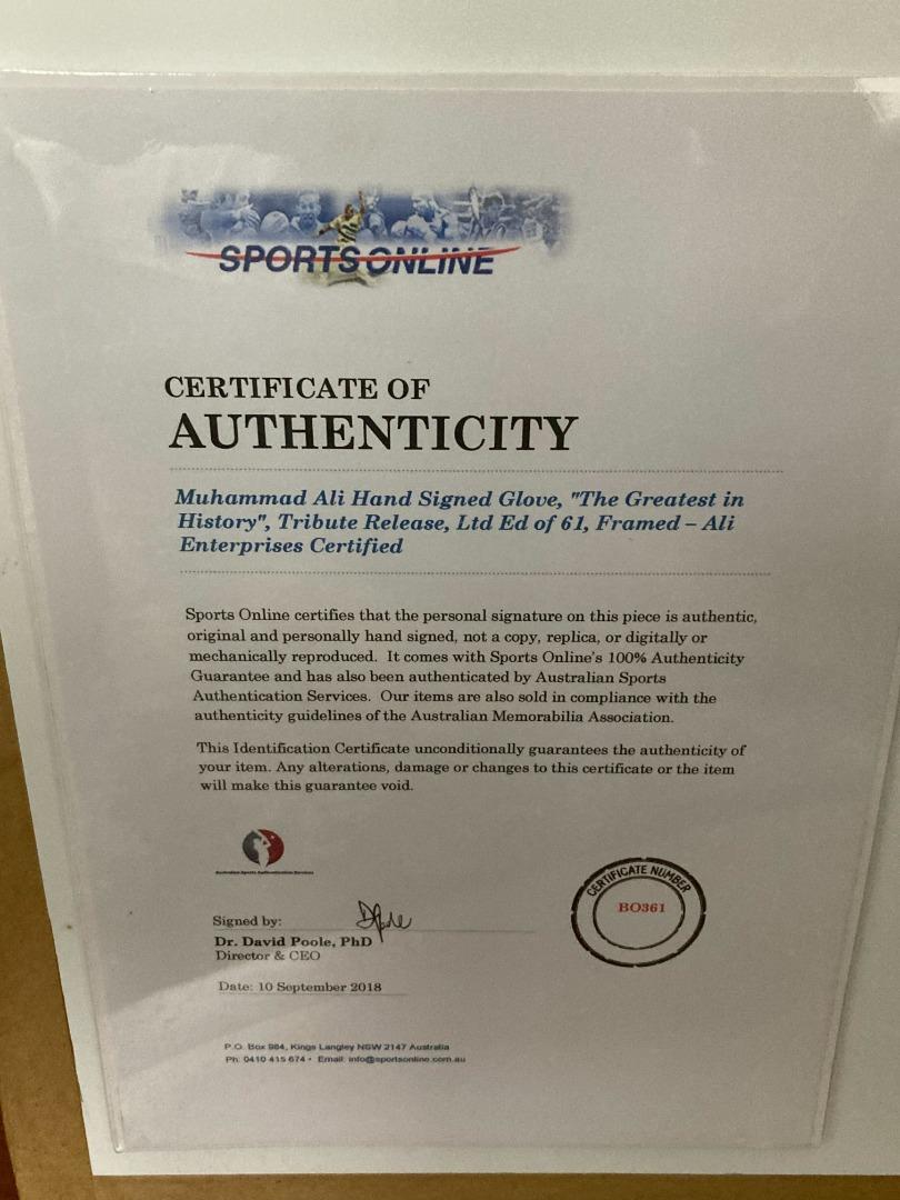 Signed Muhammad Ali boxing glove in cabinet with certificate of