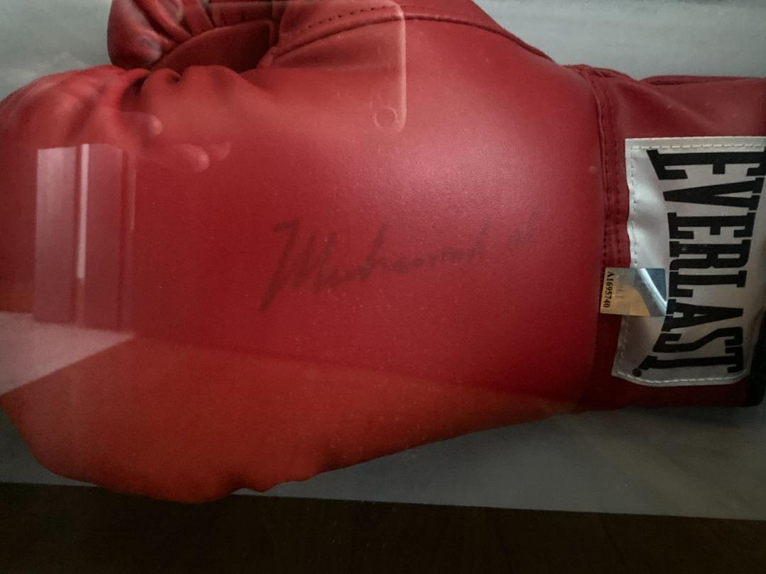 Signed Muhammad Ali boxing glove in cabinet with certificate of