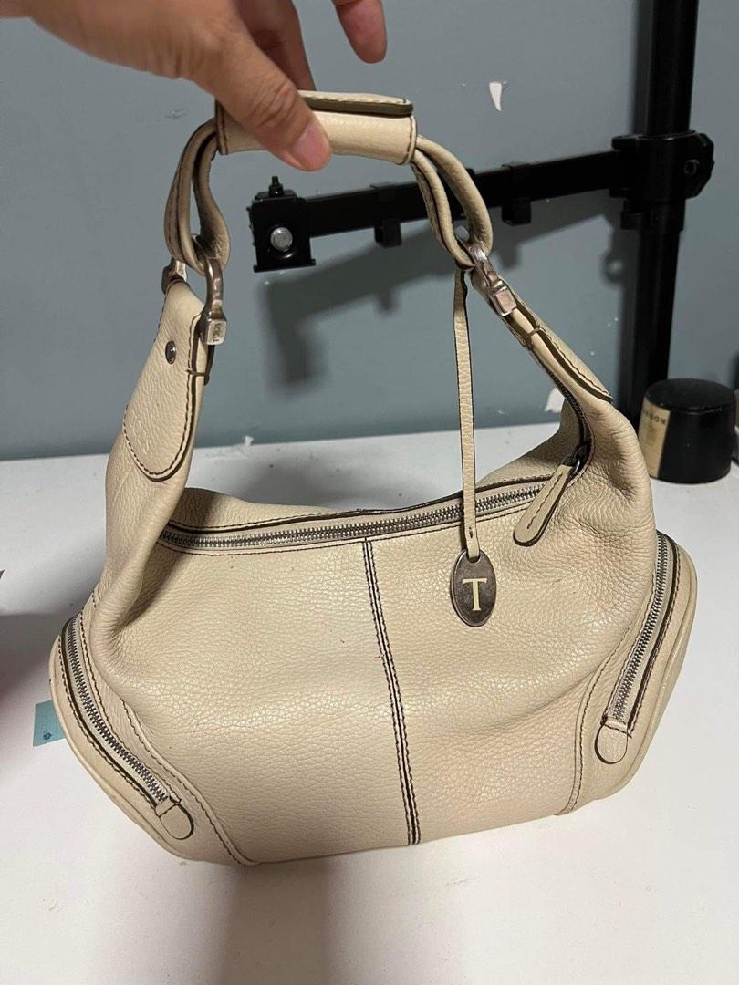 Tod's Mini Hobo Leather Handbag (Beige) (Category: Purses & Pouches) located in Manila. Submitted by effiesells (Listing ID 1078185218, Image 2). Description: Minor marks Loosing one bag stud Genuine leather with silver hardware Two side pockets outside and an inner pocket Prices still negotiable! Kindly PM for more details or more pictures of the item! Happy shopping! xoxo, iamcheskavil.