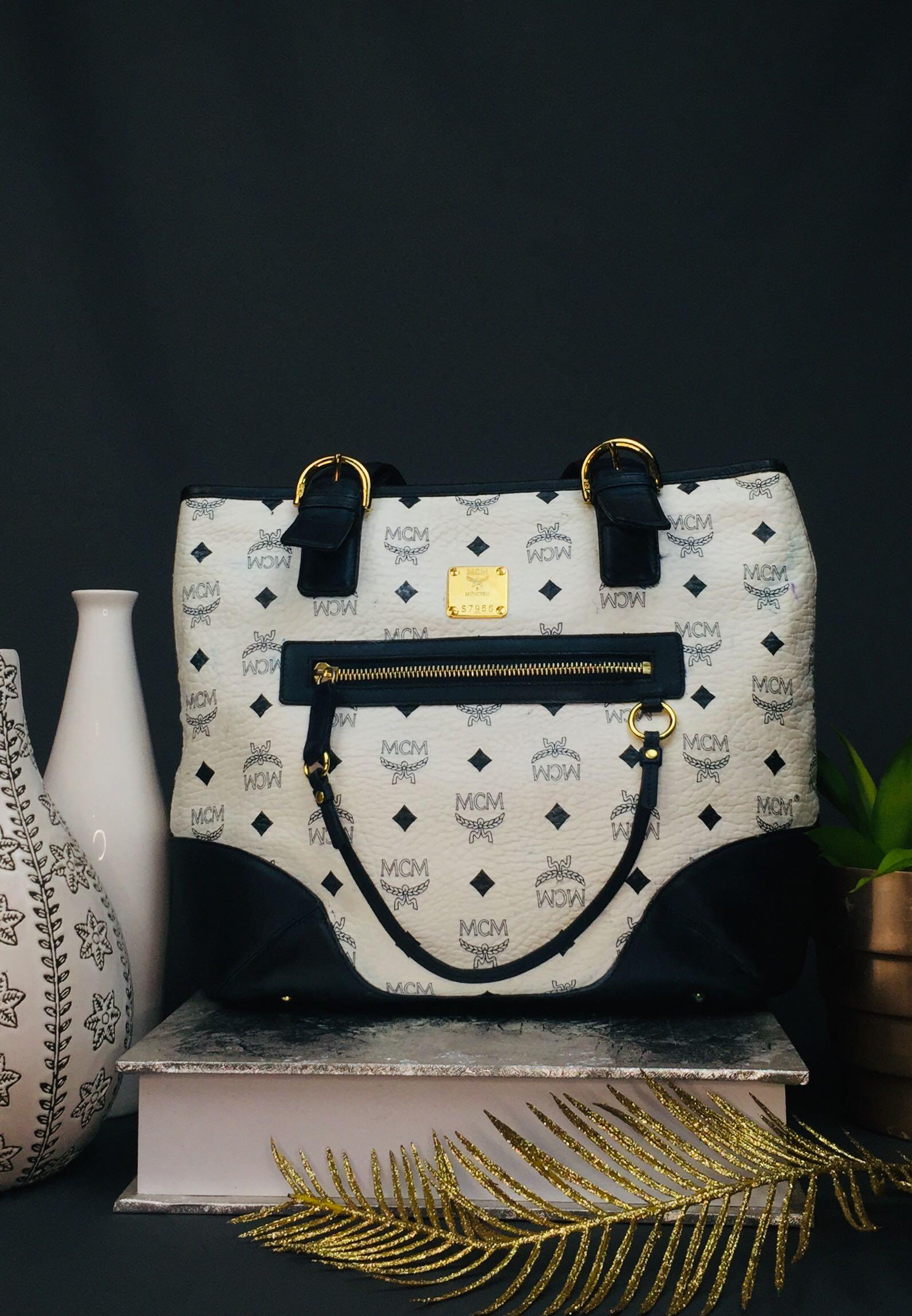 MCM tote (Category: Luxury Bags & Wallets) located in Baguio. Submitted by BagstacularbyJCT (Listing ID 1181953178, Image 1). Description: MCM Tote in Navy and white colorway. Bag has some color transfers on exterior as seen on pic. Bag is fully functional. .