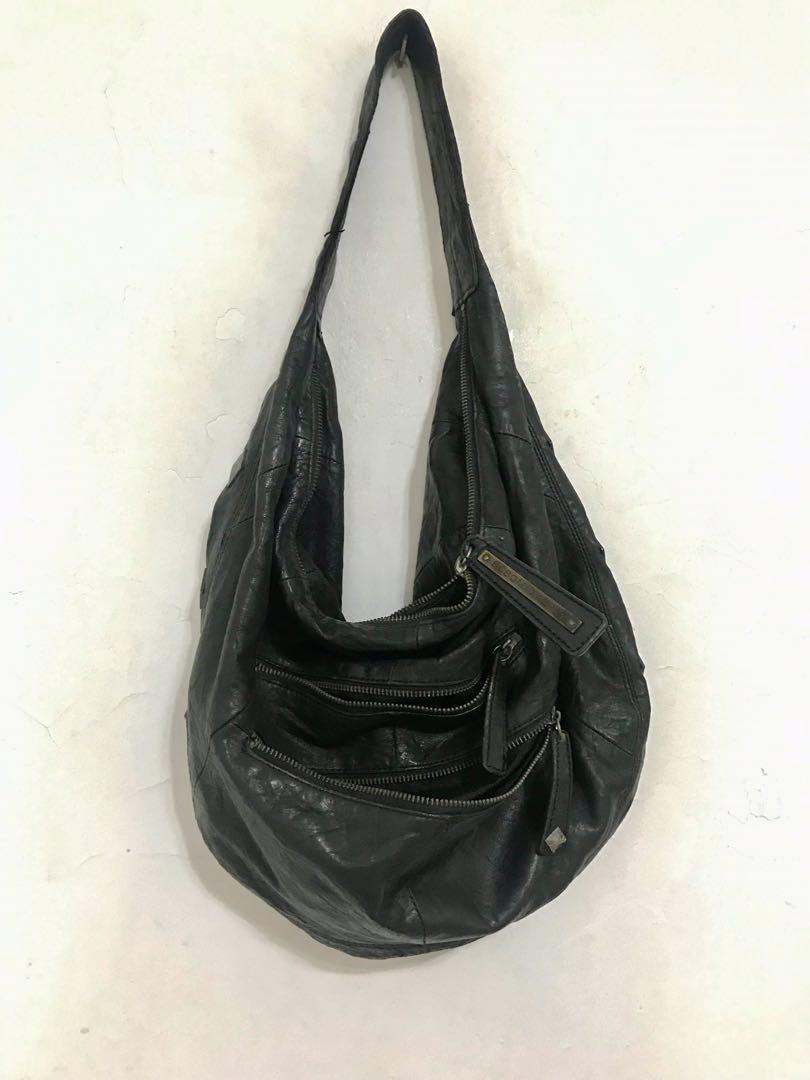 Preloved bcbg max azria leather hobo bag (Category: Luxury Bags & Wallets) located in Manila. Submitted by lineagecouture (Listing ID 1114787745, Image 1). Description: preloved black leather hobo bag authentic leather but with scratches from hanging on hooks also with some visible wear and discoloration on studs please zoom all photos and zippers not working original bcbg max azria Gcash bpi and bdo.