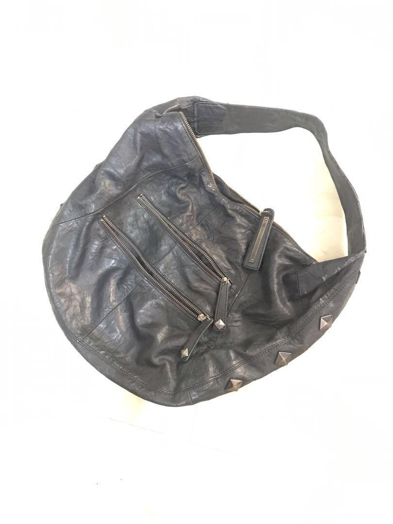 Preloved bcbg max azria leather hobo bag (Category: Luxury Bags & Wallets) located in Manila. Submitted by lineagecouture (Listing ID 1114787745, Image 2). Description: preloved black leather hobo bag authentic leather but with scratches from hanging on hooks also with some visible wear and discoloration on studs please zoom all photos and zippers not working original bcbg max azria Gcash bpi and bdo.